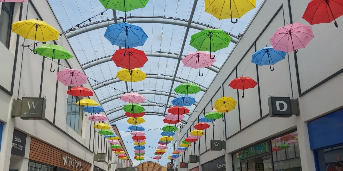 Coloured umbrellas hanging from the roof in the Lexicon shopping centre in Bracknell