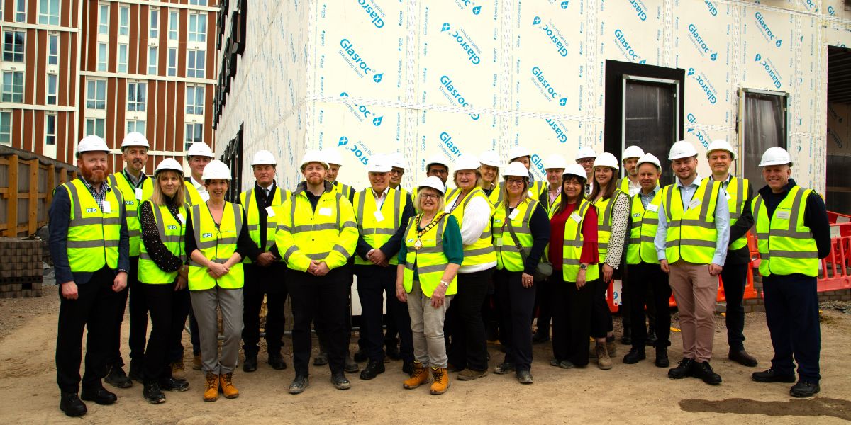 Bracknell's Mayor and MP pose in front of what will be Bracknell Forest Centre for Health, together with representatives from Bracknell Forest Council, NHS England, local NHS organisations and the two GP practices which will call the centre home
